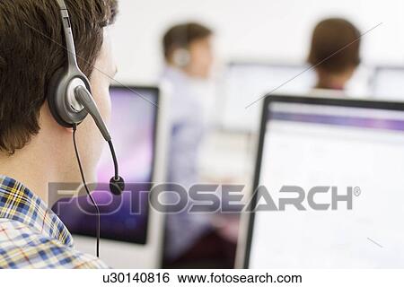 Stock Photograph - Business people working in headsets. Fotosearch