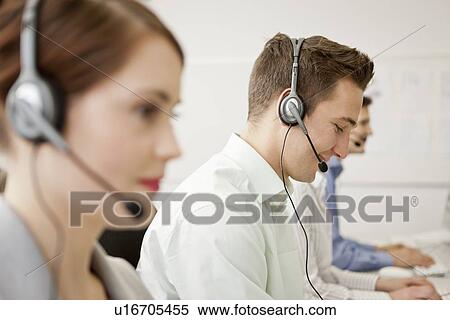 Business people working in headsets View Large Photo Image Stock Photography - Business people working in headsets. Fotosearch