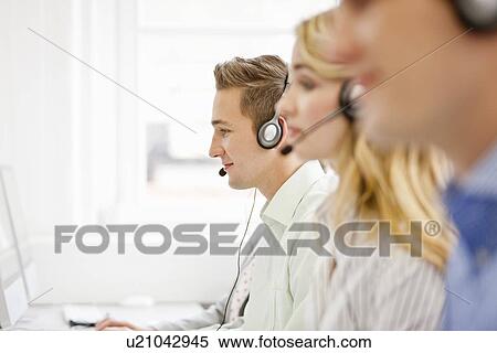 Business people working in headsets View Large Photo Image Stock Photography - Business people working in headsets. Fotosearch