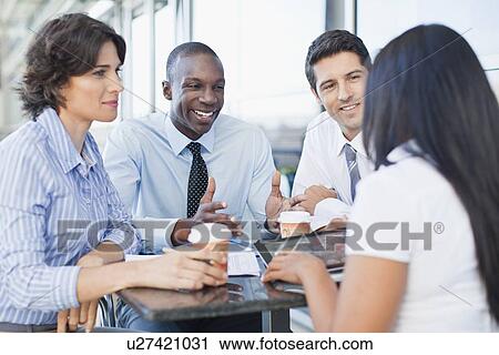 Business people working together in cafe View Large Photo Image Stock Image - Business people working together in cafe. Fotosearch