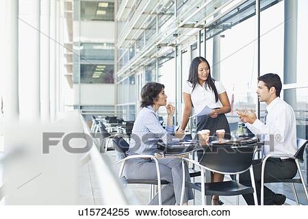 Business people working together in cafe View Large Photo Image Stock Photography - Business people working together in cafe. Fotosearch