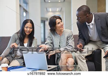 Stock Image - Business people working together. Fotosearch