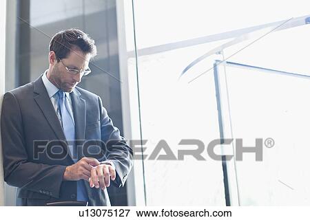 Stock Photo - Businessman checking his watch. Fotosearch