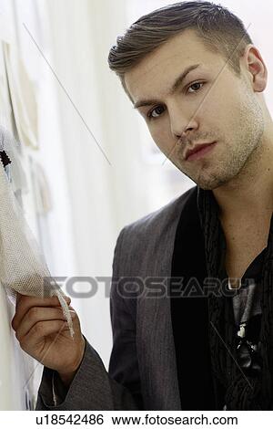 Stock Photograph - Businessman examining fabric. Fotosearch