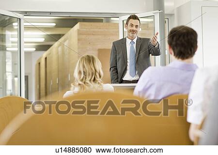 Businessman hosting seminar in office View Large Photo Image Stock Image - Businessman hosting seminar in office. Fotosearch