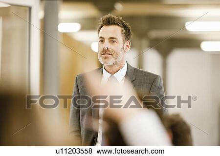 Businessman hosting seminar in office View Large Photo Image Stock Photo - Businessman hosting seminar in office. Fotosearch