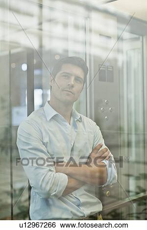 Stock Photograph - Businessman riding glass elevator. Fotosearch