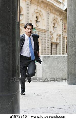 Businessman running on city street View Large Photo Image Picture - Businessman running on city street. Fotosearch