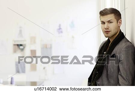 Businessman standing in office View Large Photo Image Stock Image - Businessman standing in office. Fotosearch