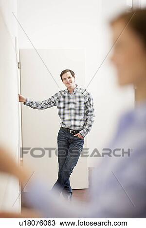 Stock Image - Businessman standing in office. Fotosearch