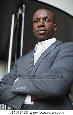 Businessman standing with arms folded View Large Photo Image Stock Image - Businessman standing with arms folded. Fotosearch