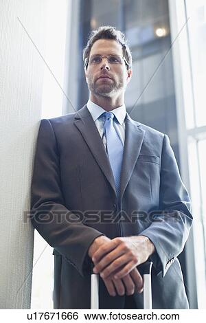 Stock Photograph - Businessman standing with hands folded. Fotosearch