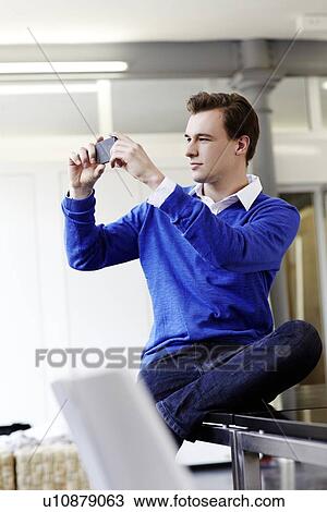 Businessman taking cell phone picture View Large Photo Image Stock Image - Businessman taking cell phone picture. Fotosearch