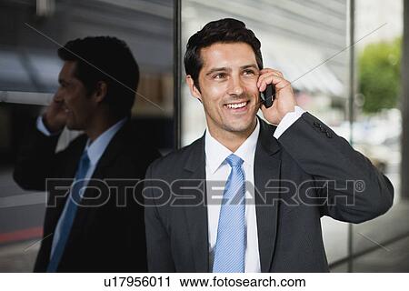 Stock Image - Businessman talking on cell phone. Fotosearch