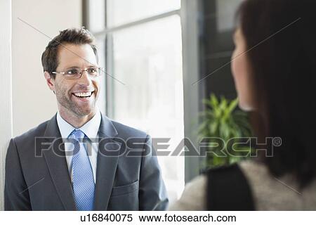Businessman talking to colleague View Large Photo Image Stock Photography - Businessman talking to colleague. Fotosearch
