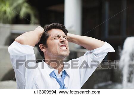 Businessman tearing at his hair View Large Photo Image Picture - Businessman tearing at his hair. Fotosearch