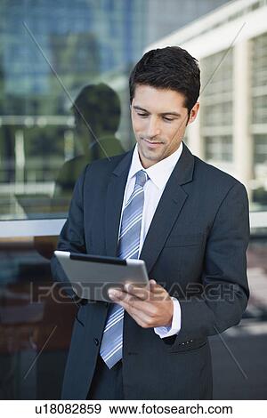 Stock Photo - Businessman using tablet computer. Fotosearch