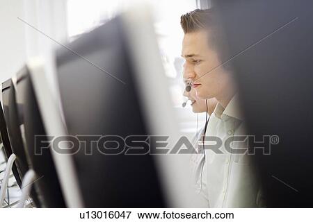 Businessman working in headset View Large Photo Image Stock Photo - Businessman working in headset. Fotosearch