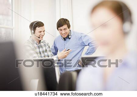Businessmen in headsets talking View Large Photo Image Picture - Businessmen in headsets talking. Fotosearch