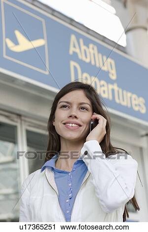 Businesswoman on cell phone at airport View Large Photo Image Stock Image - Businesswoman on cell phone at airport. Fotosearch