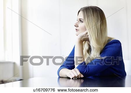 Businesswoman sitting at desk View Large Photo Image Stock Photograph - Businesswoman sitting at desk. Fotosearch