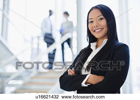 Businesswoman smiling in office View Large Photo Image Stock Image - Businesswoman smiling in office. Fotosearch