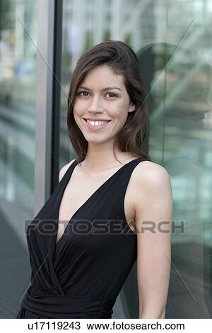 Stock Image - Businesswoman smiling outdoors. Fotosearch