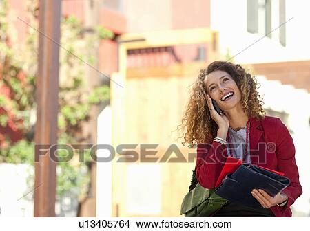 Picture - Businesswoman talking on cell phone. Fotosearch