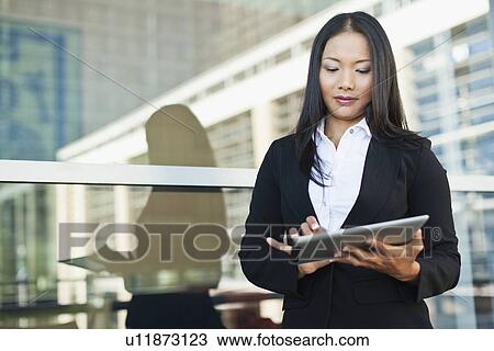 Businesswoman using tablet computer View Large Photo Image Stock Image - Businesswoman using tablet computer. Fotosearch