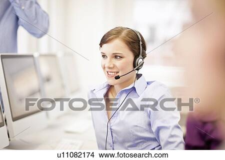 Businesswoman working in headset View Large Photo Image Picture - Businesswoman working in headset. Fotosearch