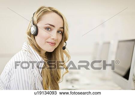 Businesswoman working in headset View Large Photo Image Stock Image - Businesswoman working in headset. Fotosearch