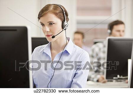 Businesswoman working in headset View Large Photo Image Stock Image - Businesswoman working in headset. Fotosearch