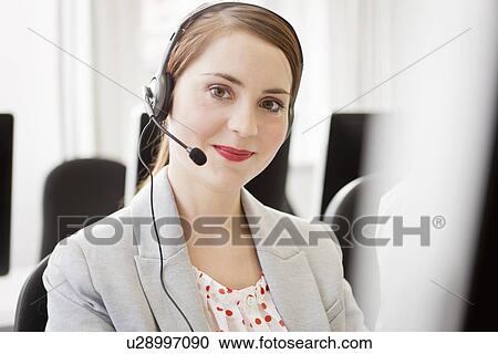 Businesswoman working in headset View Large Photo Image Stock Image - Businesswoman working in headset. Fotosearch