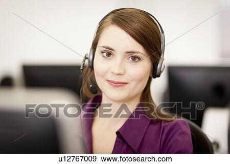 Stock Photo - Businesswoman working in headset. Fotosearch
