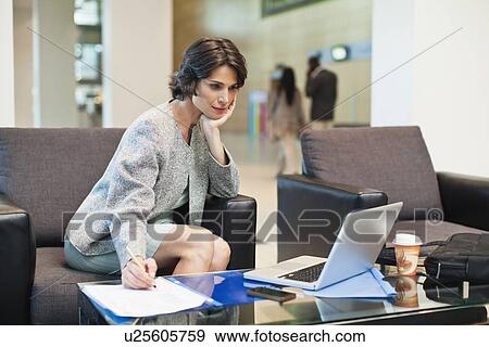 Businesswoman working in lobby View Large Photo Image Stock Photo - Businesswoman working in lobby. Fotosearch