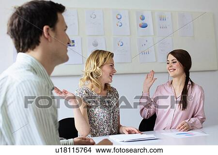Businesswomen high fiving in office View Large Photo Image Picture - Businesswomen high fiving in office. Fotosearch