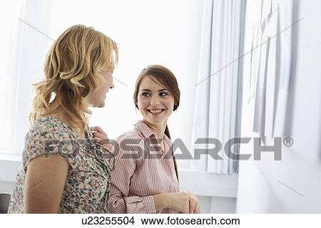 Picture - Businesswomen smiling in office. Fotosearch