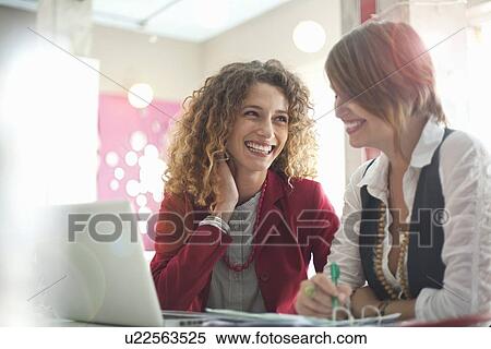 Stock Photography - Businesswomen working together. Fotosearch
