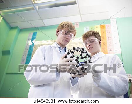Stock Image - Chemistry students examining models. Fotosearch