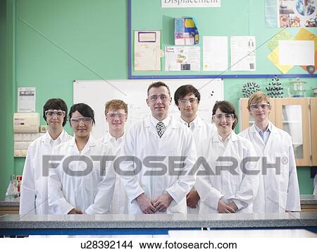 Picture - Chemistry teacher and students in lab. Fotosearch