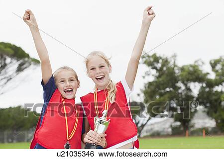 Stock Photograph - Children cheering with medal. Fotosearch