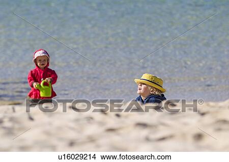 Picture - Children playing on sandy beach. Fotosearch
