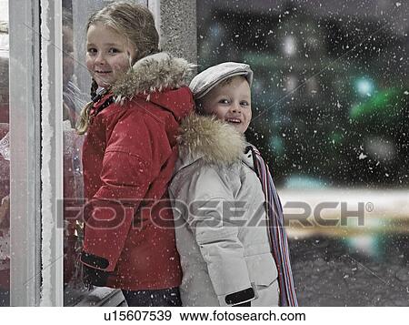 Stock Photo - Children smiling in snow. Fotosearch