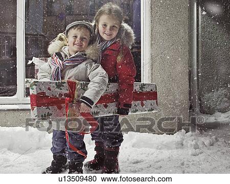 Children with Christmas present in snow View Large Photo Image Stock Image - Children with Christmas present in snow. Fotosearch