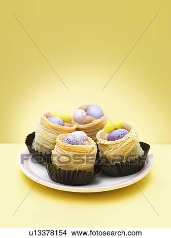 Chocolate eggs in decorative nests View Large Photo Image Picture - Chocolate eggs in decorative nests. Fotosearch