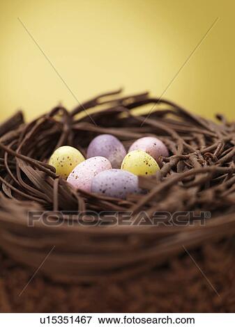 Stock Photo - Close up of chocolate eggs in nest. Fotosearch