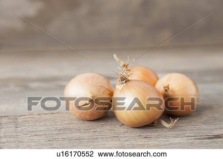 Stock Image - Close up of onions on table. Fotosearch