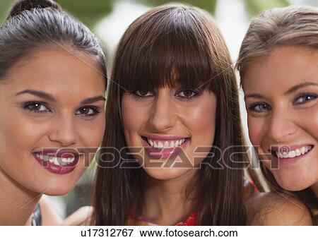 Stock Photo - Close up of women smiling together. Fotosearch