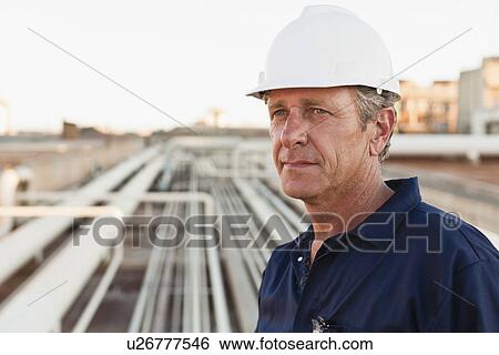 Close up of worker at oil refinery View Large Photo Image Stock Photograph - Close up of worker at oil refinery. Fotosearch