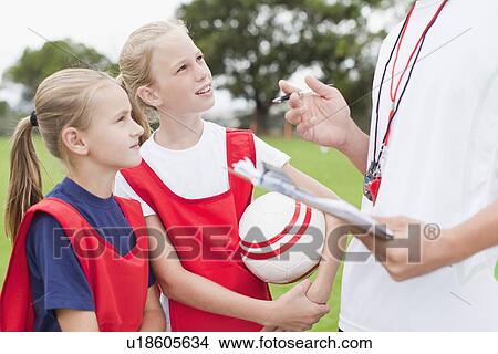 Coach talking to children on soccer team View Large Photo Image Picture - Coach talking to children on soccer team. Fotosearch